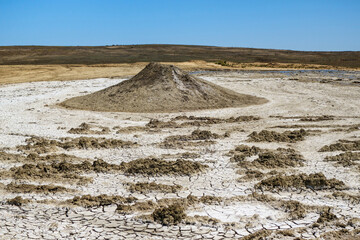 Fototapeta na wymiar Panorama of mud volcano & landscape around. It looks like miniature of real mountain, landscape a bit surreal, just like surface of different planet