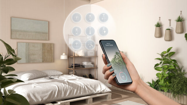 Smart home technology interface on phone app, augmented reality, internet of things, interior design of wooden bedroom with connected objects, woman hand holding remote control