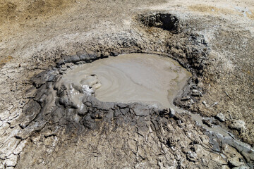 Gas bubble blowing before explode inside crater of mud volcano. Shot in Bulganak field, near Kerch, Crimea