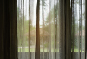 Light brown curtains and soft have light the scenery the outside