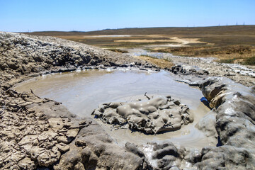 Gas bubble during its explode inside crater of mud volcano. Shot in Bulganak field, near Kerch, Crimea © Poliorketes