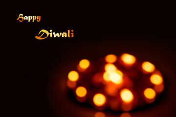 Happy Diwali background image with text and copy space. An abstract blur picture of lit diya oil...