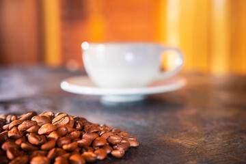Coffee cups and coffee beans on a wooden background