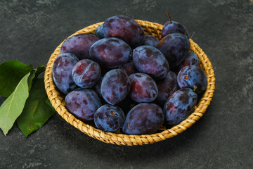Ripe plum heap in the basket
