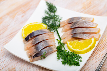 Marinated herring fillet with sliced lemon and dill, healthy food