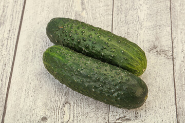 Green fresh cucumbers over background