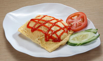 Nasi goreng pattaya, or simply nasi pattaya, is a Southeast Asian fried rice dish made by covering or wrapping chicken fried rice, in thin fried egg or omelette. 