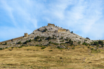 Panorama inside the medieval Genoese fortress, Sudak, Crimea. Remains of the tower at top of mountain were the residence of commander, it is called the Tower of Saint Elijah