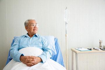 Senior man recovered from his illness and checked out from the hospital. He has a bright and...