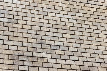 Surface of a yellow brick wall.