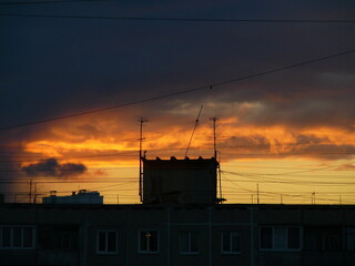 colorful sunset in the city and dark clouds