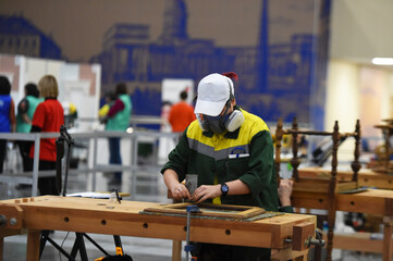 people in masks are working on projects indoors