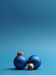 Blue vintage Christmas baubles on a blue background with space for your text or image, seasonal holiday card