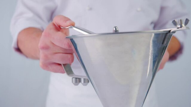 Pastry Chef Making Dessert. The Red Berry Sauce Pouring Out On A White Background In Slow Motion. Red Sauce Pouring On A White Table.