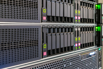 The front panel of hosting servers is in the datacenter. Computer hardware works in the server room. Modern hardware of the Internet provider. - obrazy, fototapety, plakaty