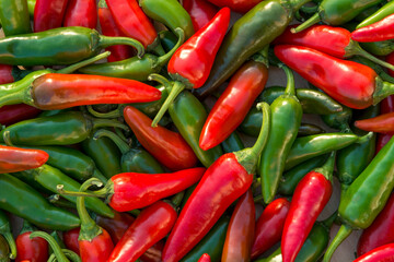 Shot of  green and red hot chili peppers on the table
