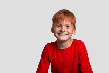 Shot of attractive red-haired smiling boy , isolated