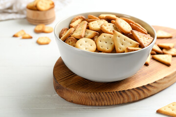 Delicious crispy crackers on white table, closeup