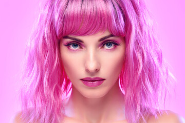 Beauty Fashion woman with Colorful Pink Dyed Hair. Girl with blue eyes, perfect Makeup and Hairstyle. Beautiful smiling model portrait, fashionable pink make up, hair. Skincare concept