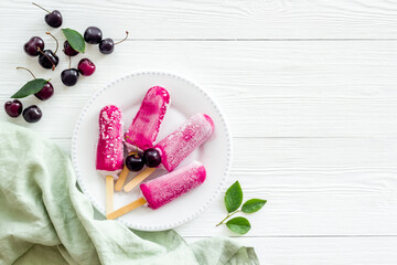 Cherry ice cream, berry popsicles on the table, top view