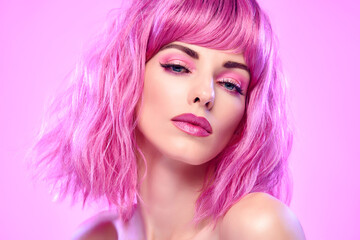 Naklejka premium Beauty Fashion woman with Colorful Pink Dyed Hair. Girl with blue eyes, perfect Makeup and Hairstyle. Beautiful smiling model portrait, fashionable pink make up, hair. Skincare concept