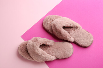 Fototapeta na wymiar Pair of stylish soft slippers on color background, flat lay