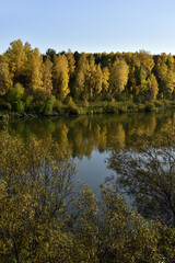 Ural river Sylva among fields and forests in autumn decoration. In the foothills of the Western Urals, golden autumn.