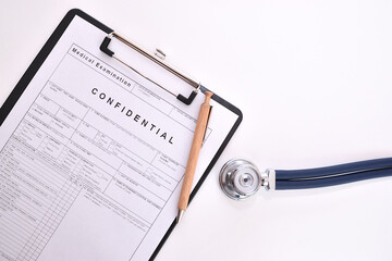 Patient examination form next to the pen and sound head from the stethoscope