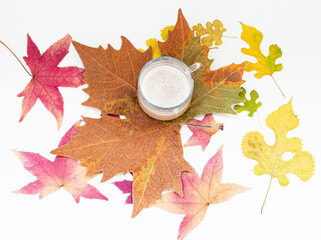 cup of coffee on an autumn leaf. Autumn mood