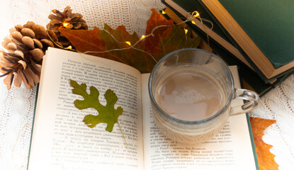 cup of coffee on an open book Autumn mood