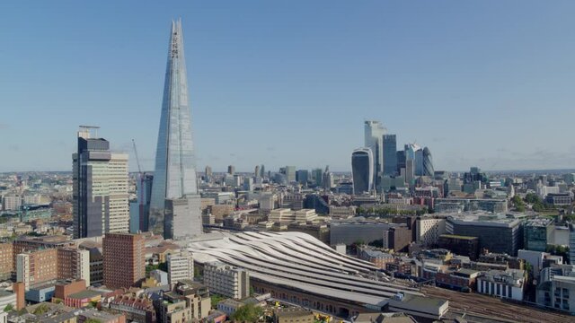Aerial Footage over London with skyline showing The Shard, London Bridge Station and the Financial District in the background.