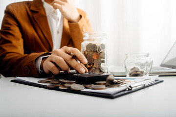 Business people use tablets and hold credit cards as an online shopping concept With a calculator and a book placed on the table