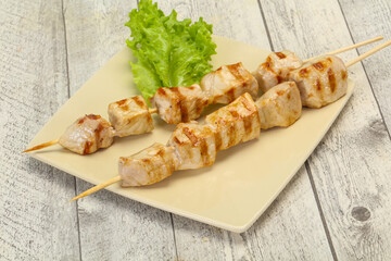 Grilled pork skewer served salad