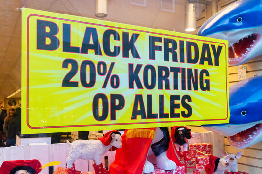 Advertisement sign in a store window with the Dutch text "Black Friday 20% discount on everything" in the city of Apeldoorn, The Netherlands on November 11, 2020