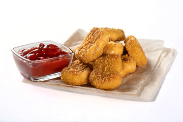 Chicken Nuggets on parchment paper with ketchup. Nuggets with ketchup insulation.