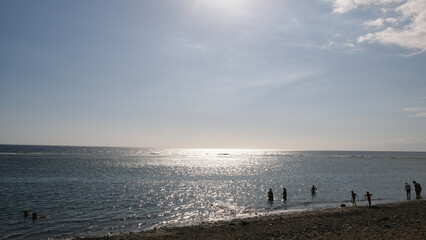 People walking on the beach att sunset
