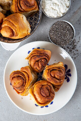 Freshly baked wheat buns with poppy seeds on the white plate