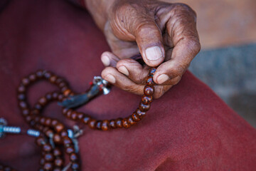 Hands of the person with rosary.