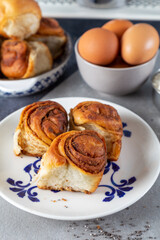 Freshly baked wheat buns with poppy seeds on the white plate