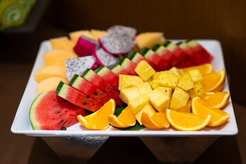 Sliced cut tropical fruit prapare on white plate