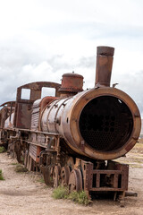Naklejka premium Old rusty locomotive abandoned in a train cemetery. Uyuni, Bolivia