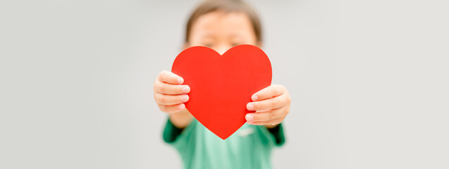 Child hands holding red heart for share Donate.Health care pediatric.family insurance.World heart...