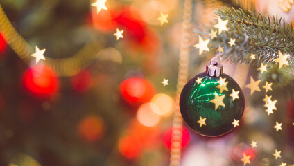 Christmas background.Decorated Christmas tree with bokeh.hanging glitter balls, trees, stars. Holiday for party posters, Winter season sparkling ornaments on a tree.Christmas balls bauble ornaments.