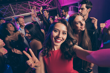 Self-portrait of nice attractive cheerful crowd dancing having fun enjoying event relax chill showing v-sign in dark night music club indoors © deagreez