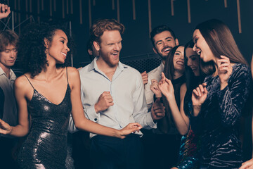 Photo of students company celebrating prom party in night club dancing laughing together wearing fashionable festive outfits