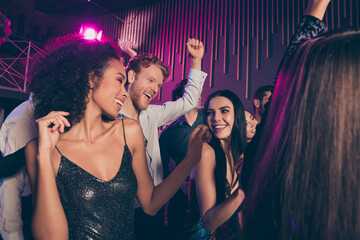 Low angle photo of young students company dancing at night club celebrating prom party together...