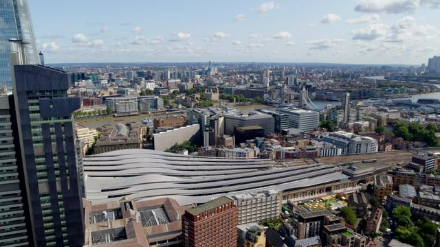 Aerial Footage over London with skyline showing The Shard, London Bridge Station and the Financial District in the background.