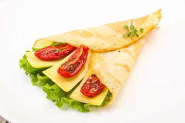 Pancake with cheese and dry tomato