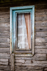 Colorful travel photograph, partial view of abandoned old house, rural landscape, Strandzha mountain, Bulgaria, wooden planks facade, window with rustic wooden frames and rusty ring