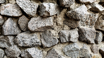 Grey masonry wall with big stones. Background texture.